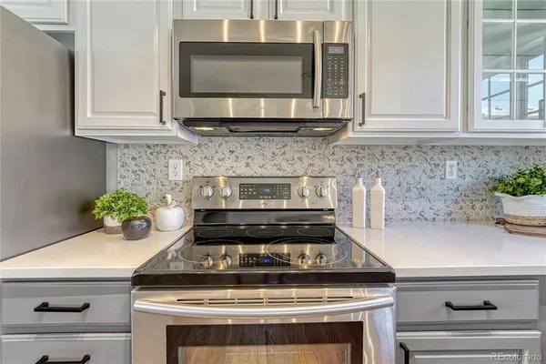 a stove top oven sitting inside of a kitchen