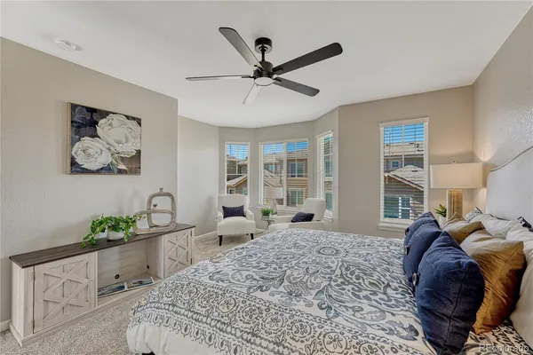 a living room with a bed furniture and decor