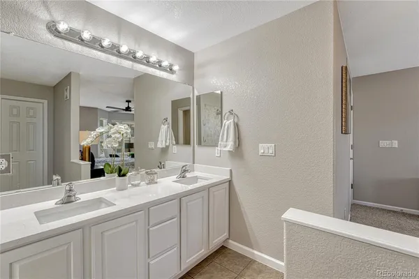 a bathroom with a double vanity sink and a mirror