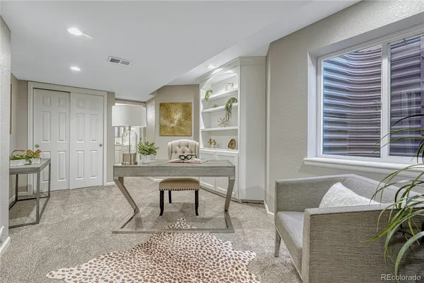 a living room with furniture a rug and a window