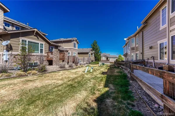 a view of a house with backyard and sitting area