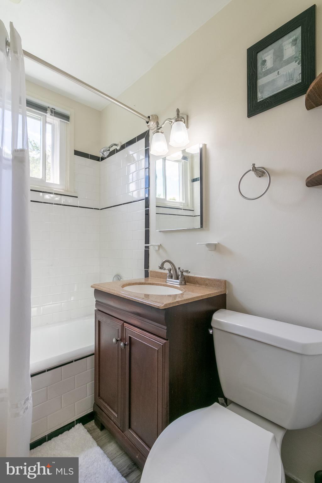 2 Laurel Hill Road Greenbelt, MD 20770 - Photo 12 of 19 a bathroom with a granite countertop toilet a sink and a mirror