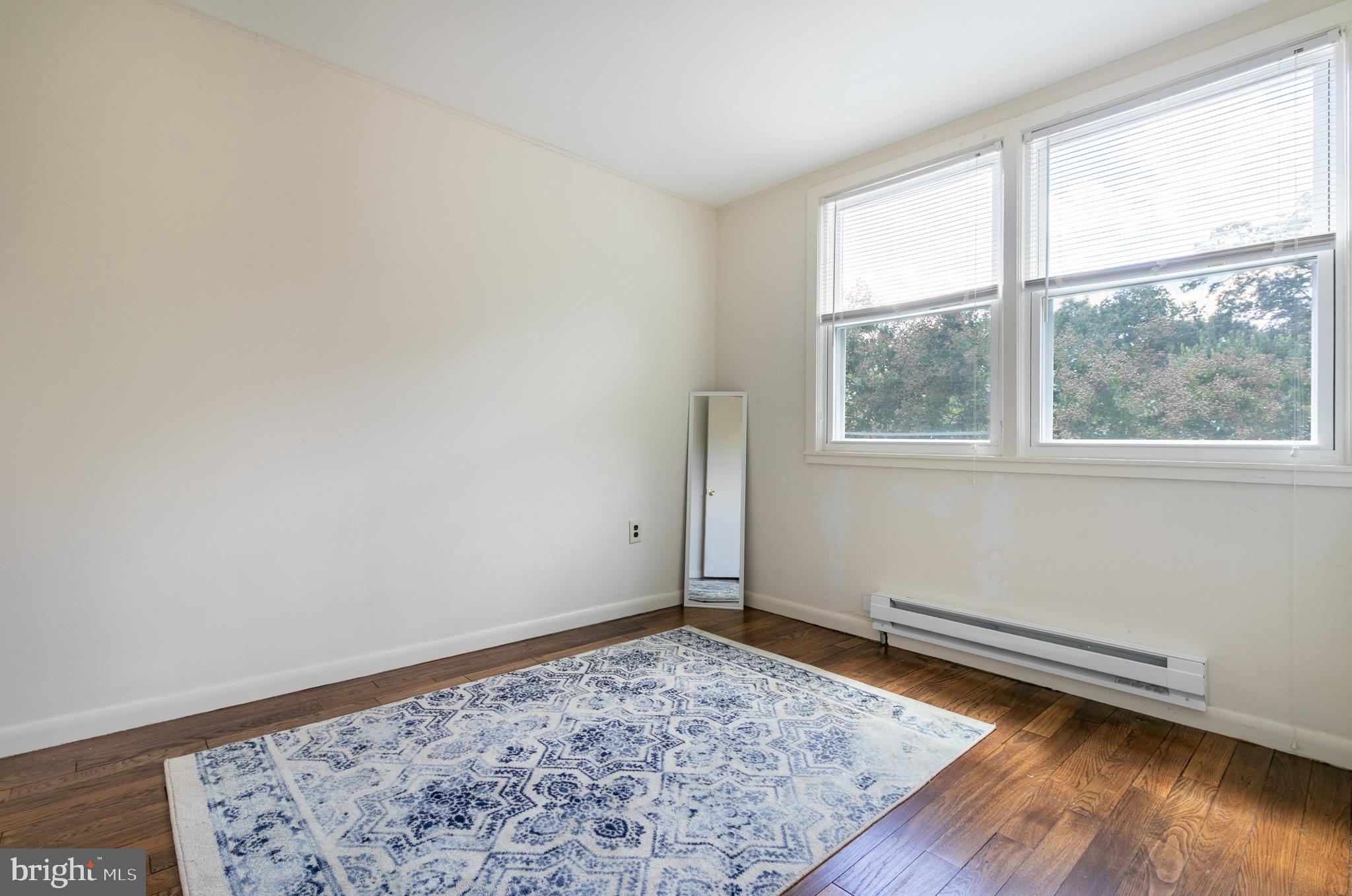 2 Laurel Hill Road Greenbelt, MD 20770 - Photo 13 of 19 an empty room with wooden floor and a window