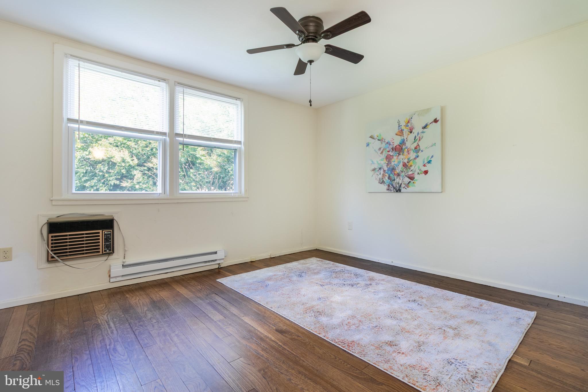 2 Laurel Hill Road Greenbelt, MD 20770 - Photo 14 of 19 an empty room with wooden floor ceiling fan and windows