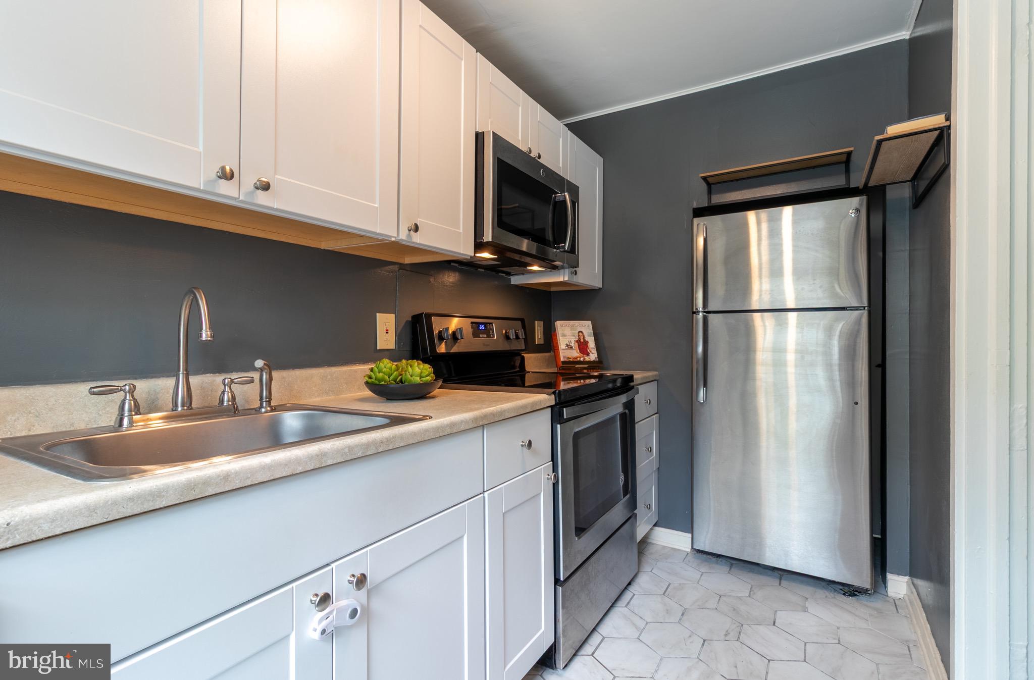 2 Laurel Hill Road Greenbelt, MD 20770 - Photo 2 of 19 a kitchen with stainless steel appliances granite countertop a refrigerator a sink a stove and white cabinets