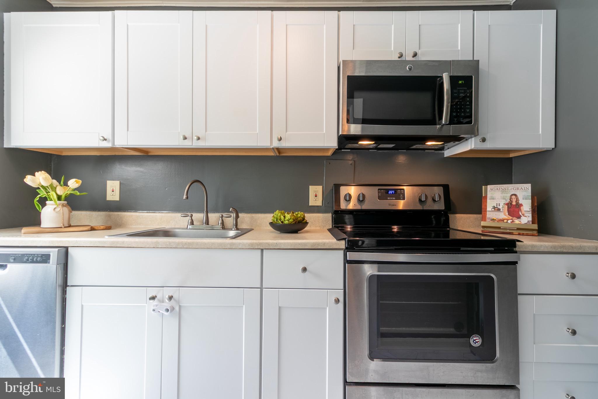 2 Laurel Hill Road Greenbelt, MD 20770 - Photo 3 of 19 a kitchen with stainless steel appliances granite countertop grey cabinets a stove a sink and dishwasher