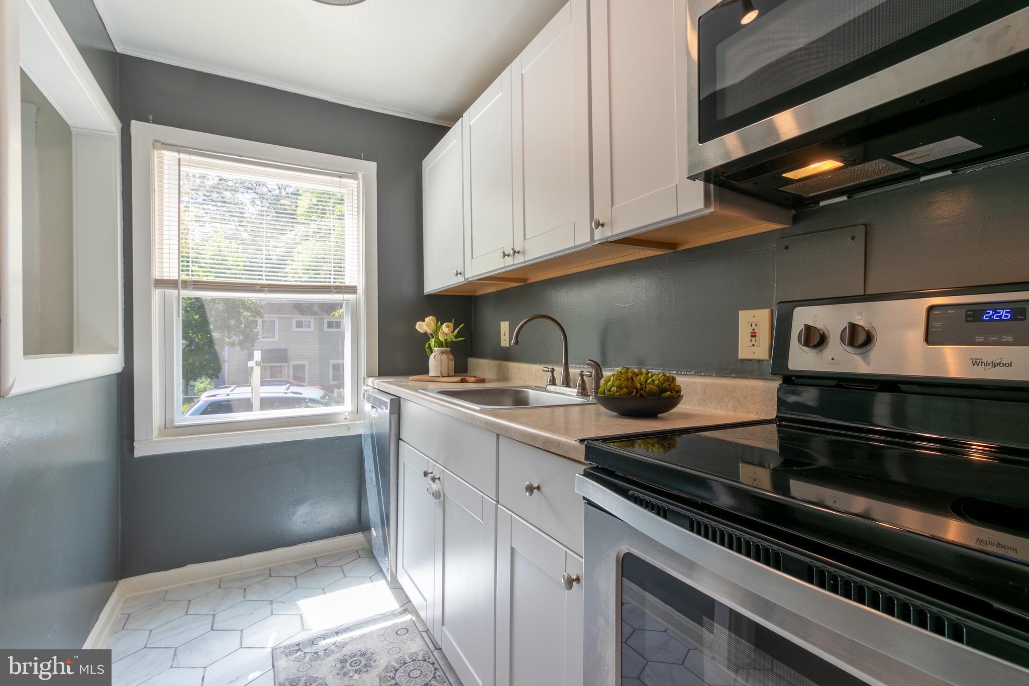 2 Laurel Hill Road Greenbelt, MD 20770 - Photo 5 of 19 a kitchen with stainless steel appliances granite countertop a sink a stove and a window