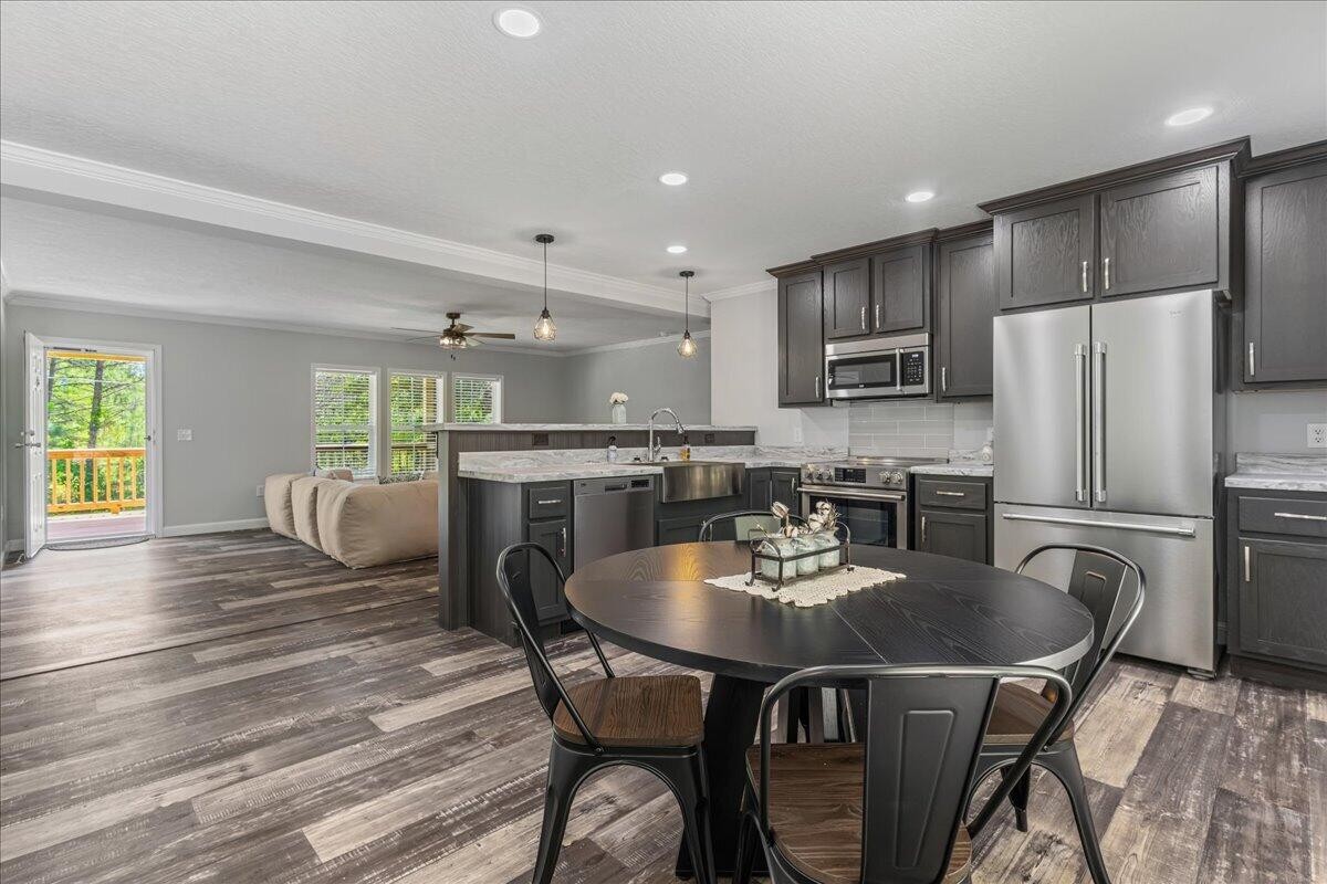1629 Wasson Road Ten Mile, TN 37880 - Photo 14 of 27 a kitchen with stainless steel appliances granite countertop a dining table chairs refrigerator and microwave