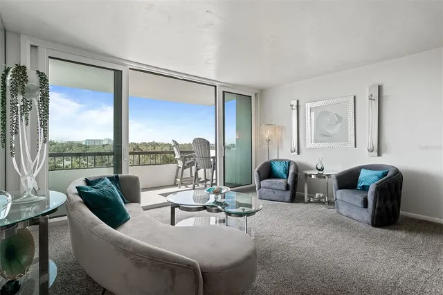 a kitchen with stainless steel appliances granite countertop a refrigerator a stove a sink and a microwave