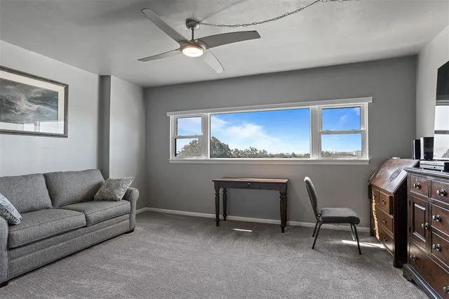 a living room with furniture a rug and a bookshelf
