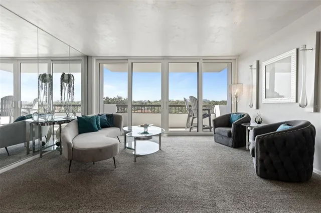 a kitchen with stainless steel appliances granite countertop a refrigerator a stove and a sink with wooden floor