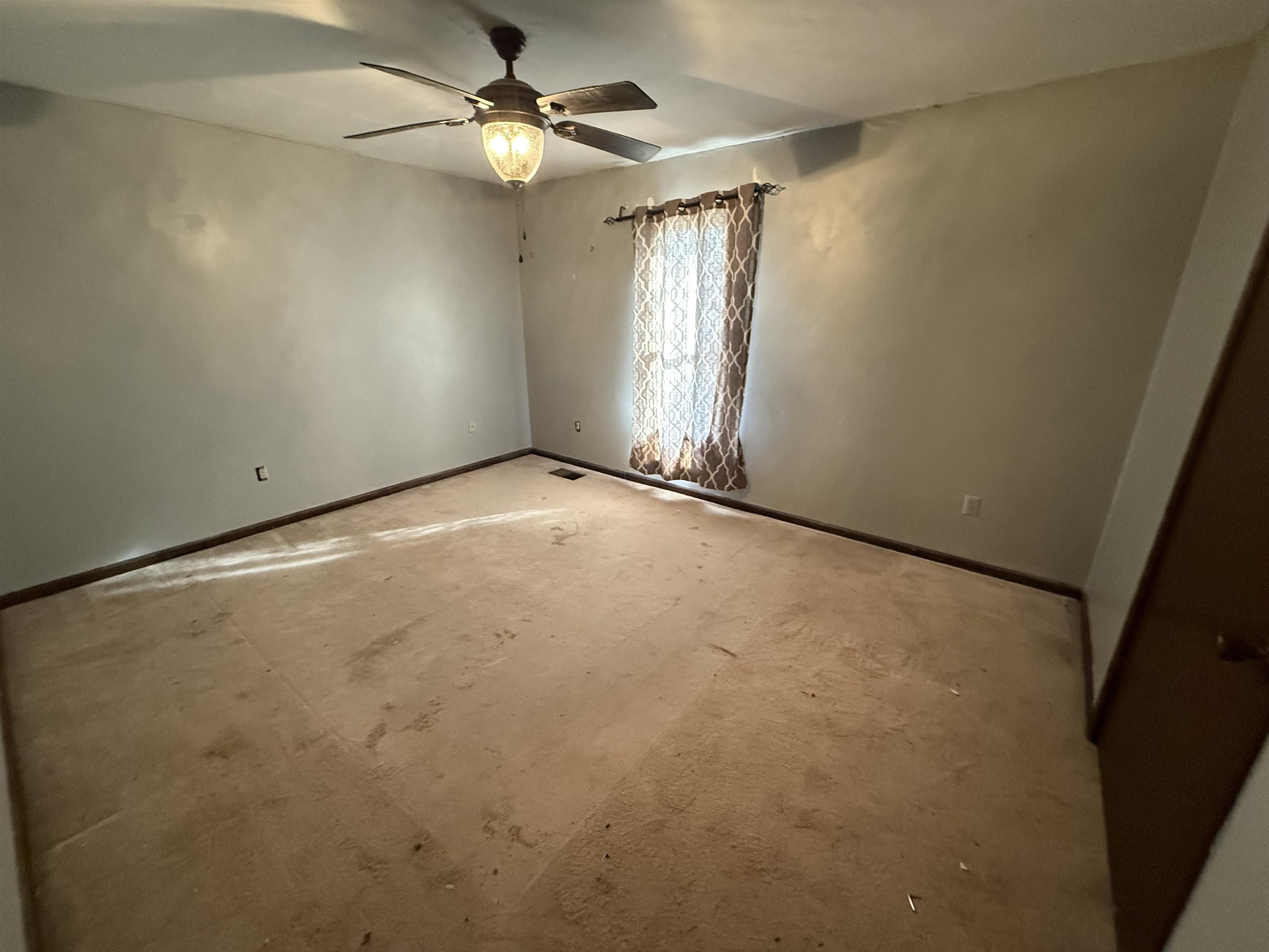 10320 Macon Road Cordova, TN 38016 - Photo 11 of 17 an empty room with windows and fan