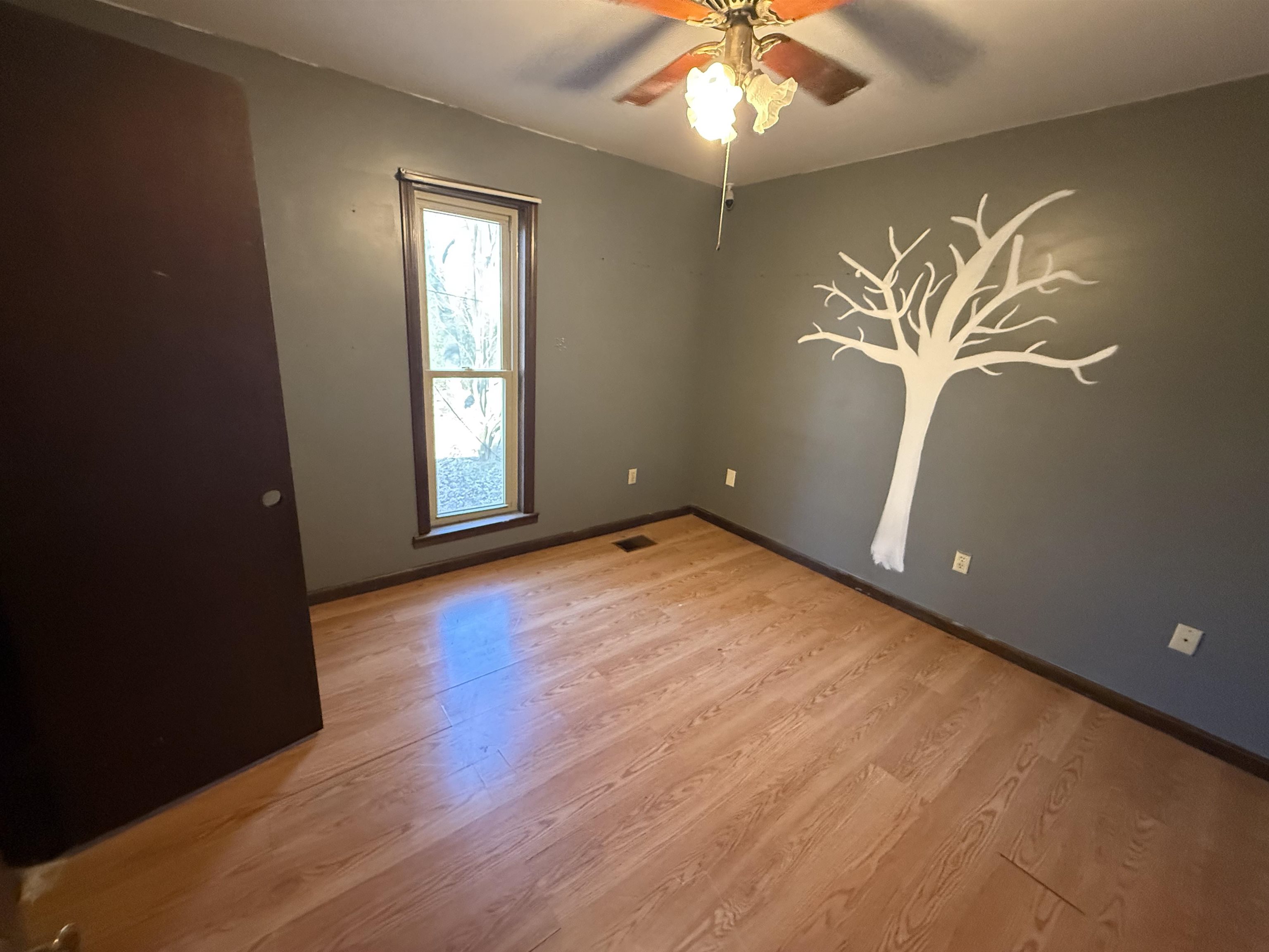 10320 Macon Road Cordova, TN 38016 - Photo 13 of 17 an empty room with wooden floor and windows