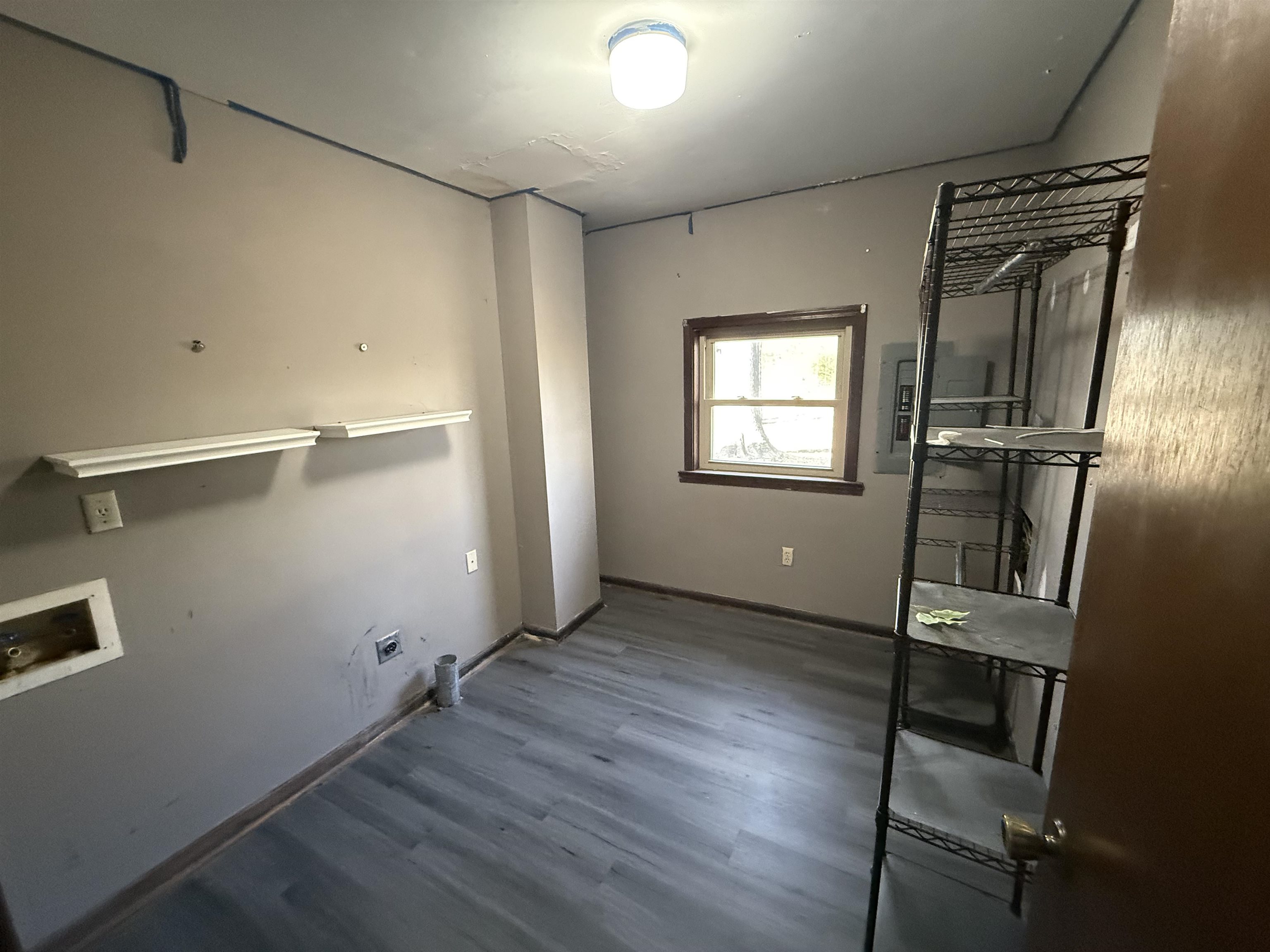 10320 Macon Road Cordova, TN 38016 - Photo 14 of 17 a view of an empty room with wooden floor and a window