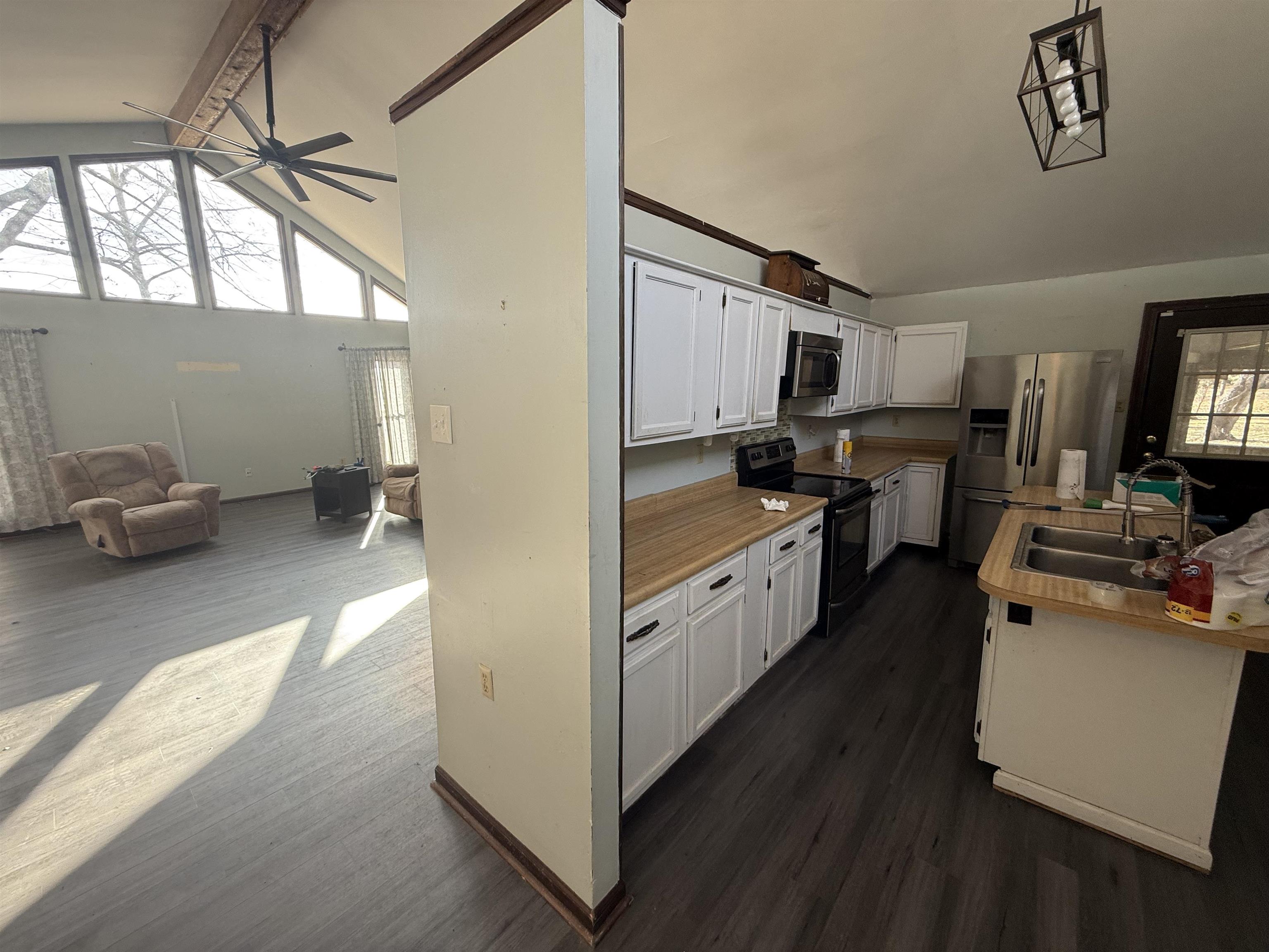 10320 Macon Road Cordova, TN 38016 - Photo 6 of 17 a kitchen with kitchen island granite countertop a sink appliances cabinets and a counter top space