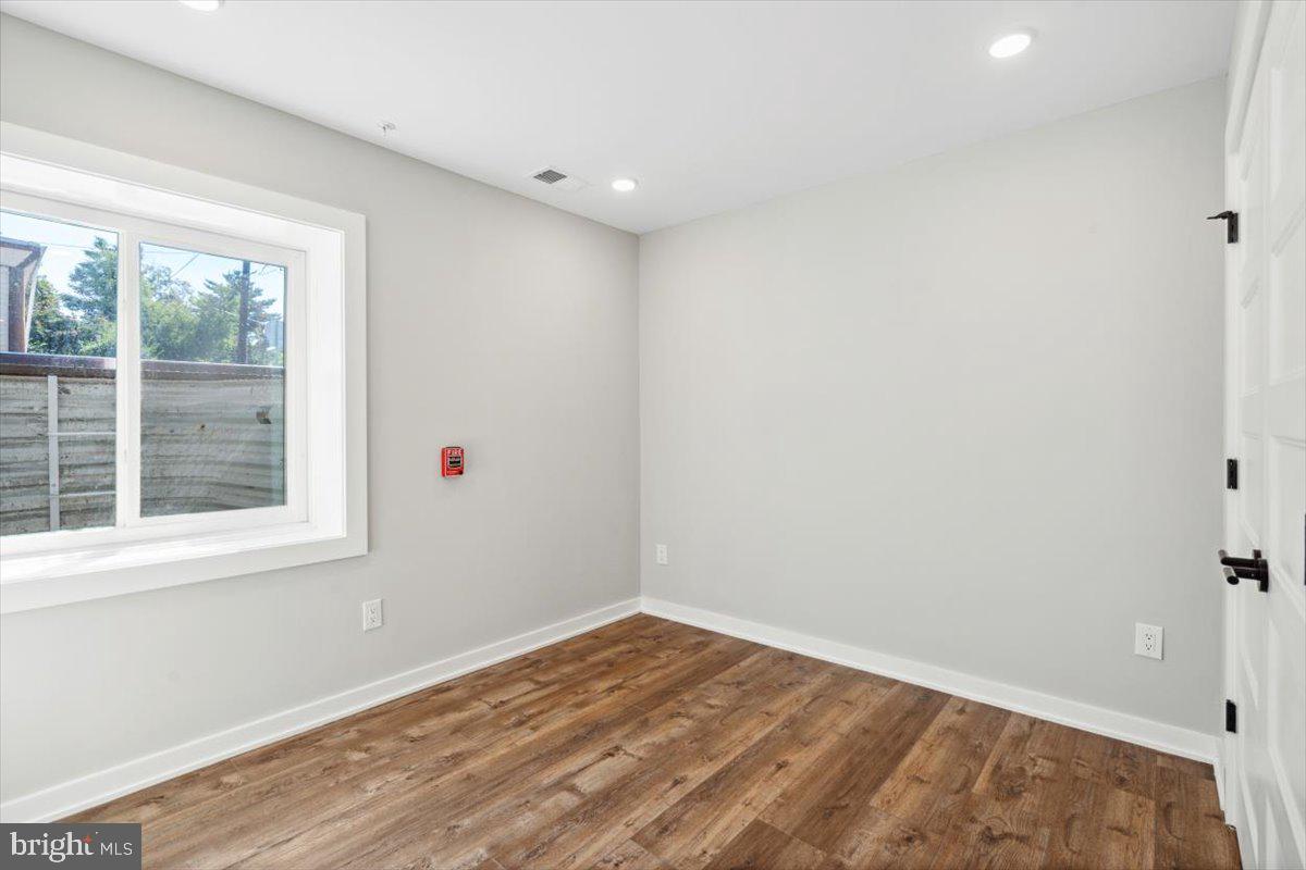 3801 Hamilton Street, Unit B Philadelphia, PA 19104 - Photo 12 of 46 an empty room with wooden floor and windows