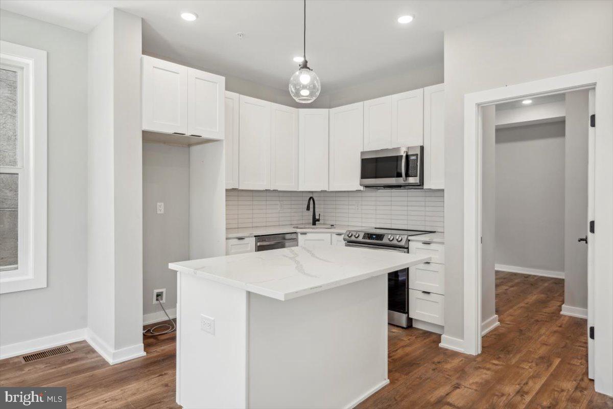 3801 Hamilton Street, Unit B Philadelphia, PA 19104 - Photo 17 of 46 a kitchen with stainless steel appliances a stove a sink and a refrigerator