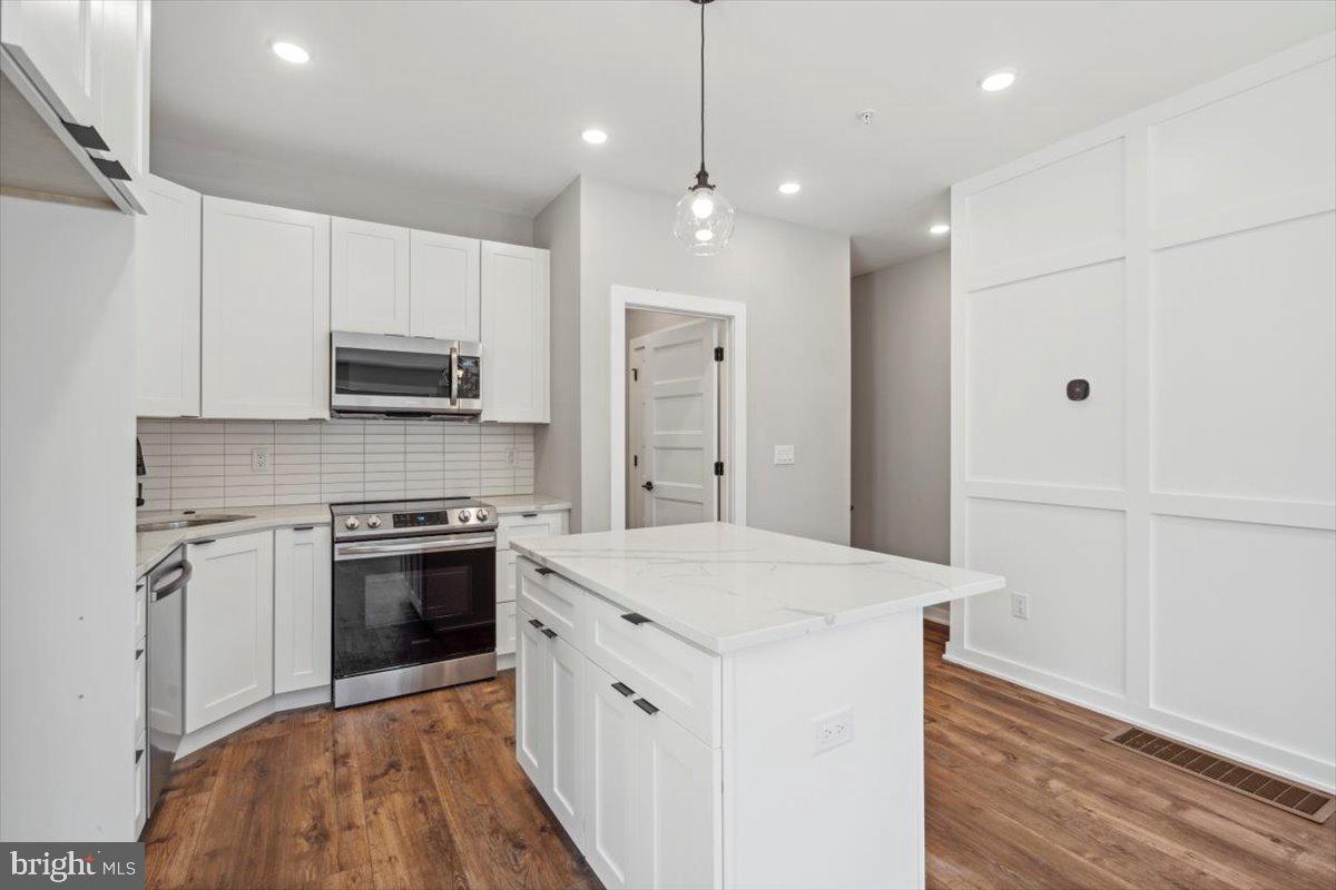 3801 Hamilton Street, Unit B Philadelphia, PA 19104 - Photo 18 of 46 a kitchen with kitchen island a sink stainless steel appliances and cabinets