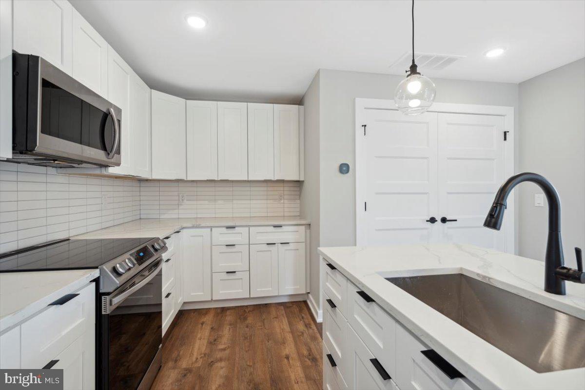 3801 Hamilton Street, Unit B Philadelphia, PA 19104 - Photo 40 of 46 a kitchen with a sink stove and microwave