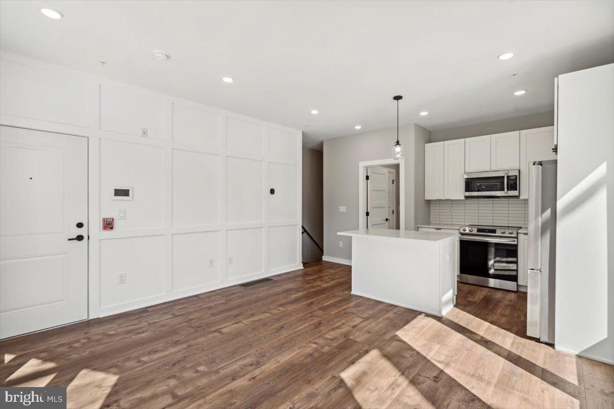 3801 Hamilton Street, Unit B Philadelphia, PA 19104 - Photo 4 of 46 a large white kitchen with white cabinets and stainless steel appliances