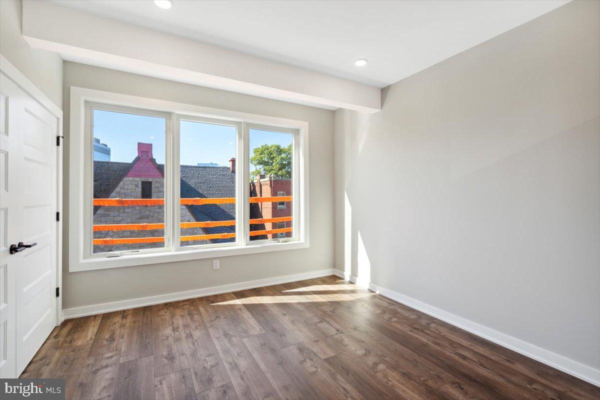 3801 Hamilton Street, Unit B Philadelphia, PA 19104 - Photo 44 of 46 an empty room with wooden floor and windows