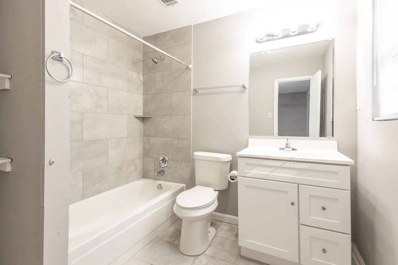 3864 Hobson Road Memphis, TN 38128 - Photo 13 of 19 Full bathroom featuring tile patterned flooring, toilet, tiled shower / bath combo, and vanity
