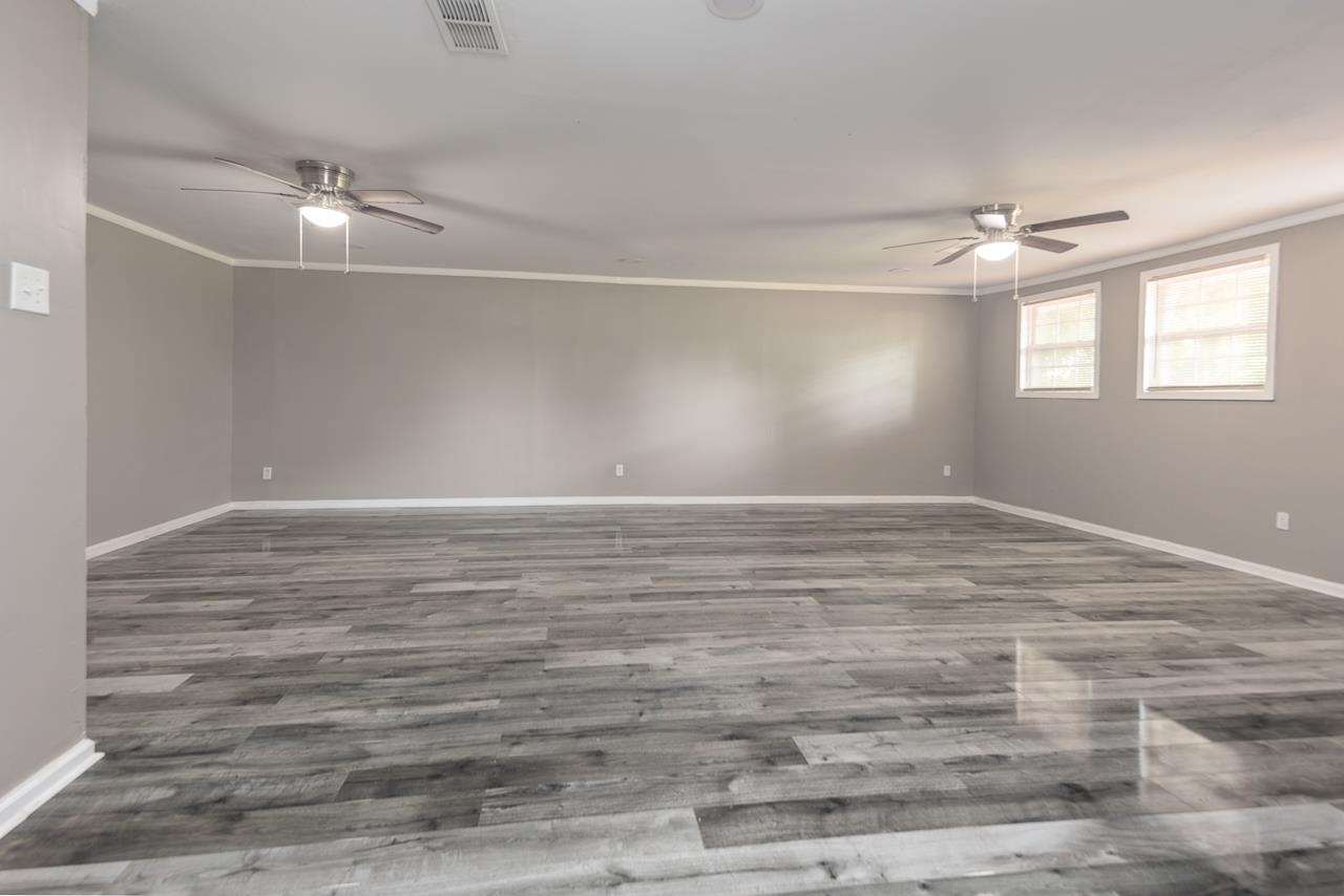 3864 Hobson Road Memphis, TN 38128 - Photo 3 of 19 Spare room with ornamental molding, wood-type flooring, and ceiling fan