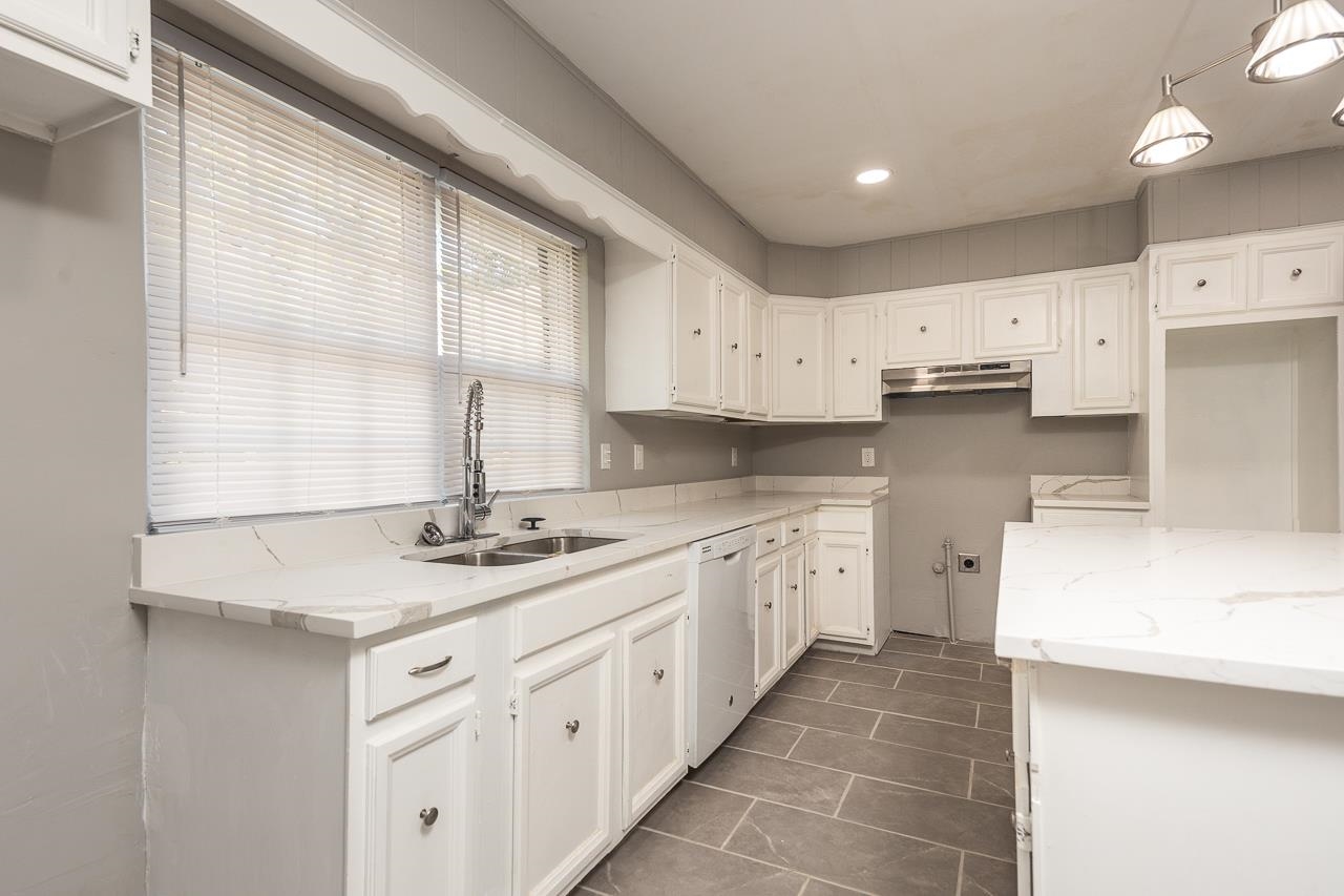 3864 Hobson Road Memphis, TN 38128 - Photo 6 of 19 Kitchen with dishwasher, pendant lighting, sink, and white cabinets