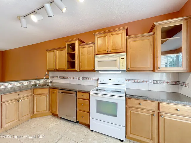 a kitchen with a stove sink and cabinets