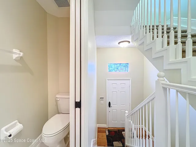 a bathroom with a toilet a sink and a mirror