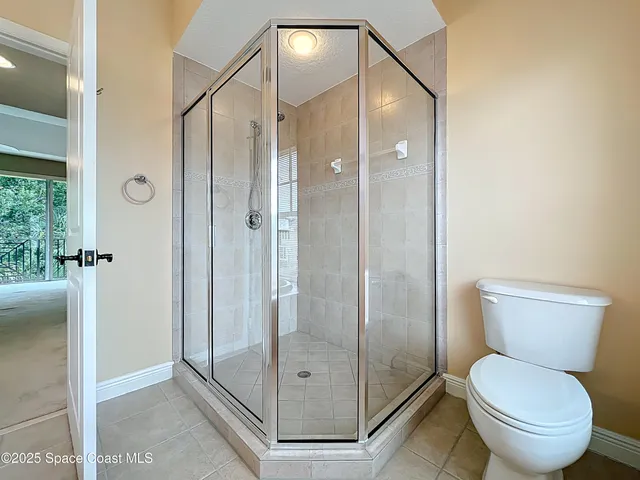 a bathroom with a shower and toilet