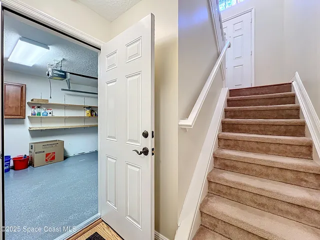 a view of an entryway with wooden floor and staircase