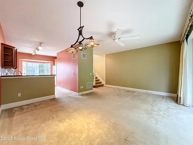 a view of a room with a ceiling fan