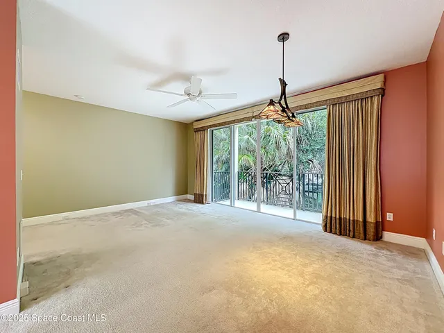 a view of an empty room with windows and cabinet