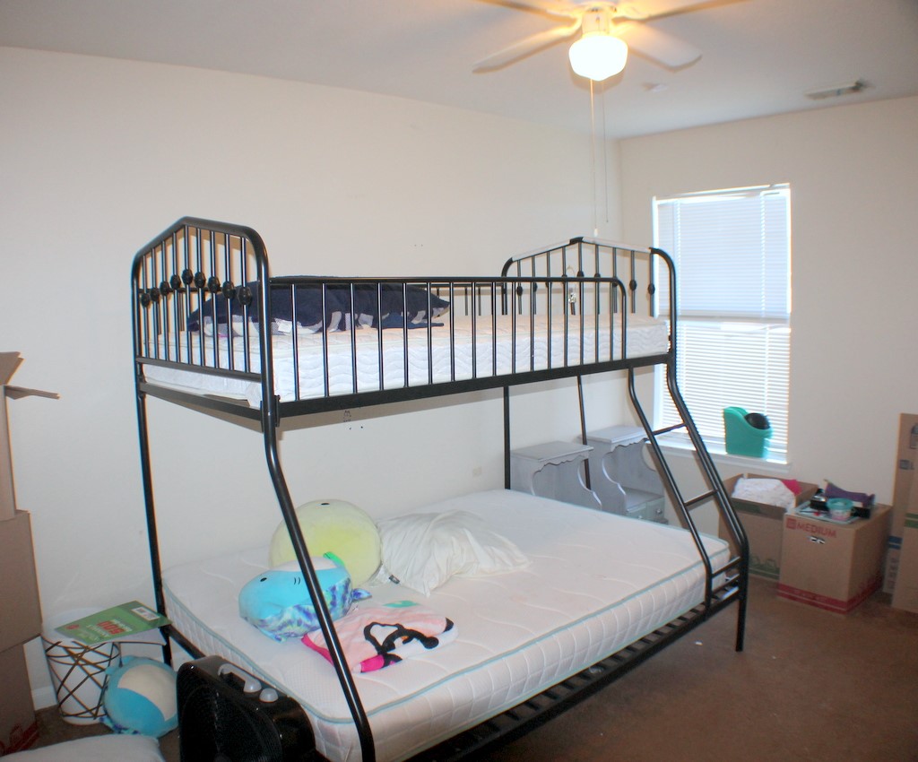 7910 Autumn Fall Street Baytown, TX 77523 - Photo 13 of 23 a bedroom with furniture and a window