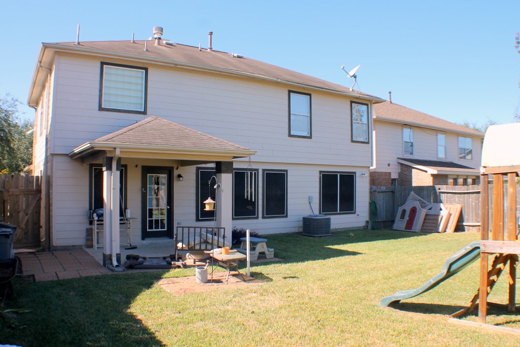 7910 Autumn Fall Street Baytown, TX 77523 - Photo 22 of 23 a front view of a house with a yard table and chairs