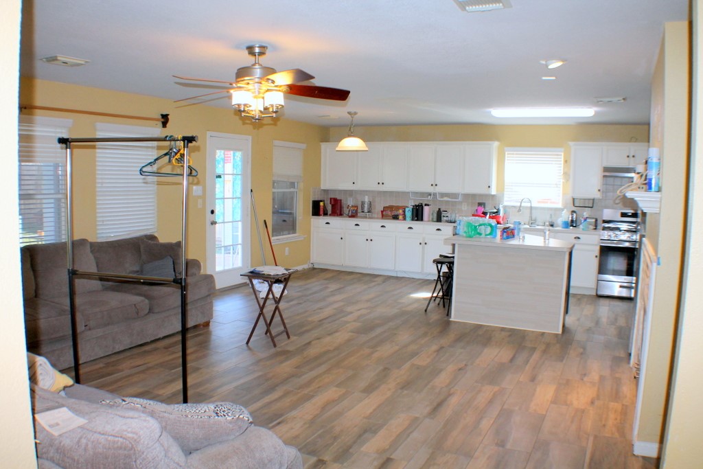 7910 Autumn Fall Street Baytown, TX 77523 - Photo 4 of 23 a living room with furniture and a chandelier