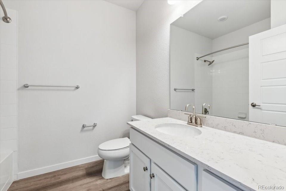 485 Interlocken Boulevard, Unit 209 Broomfield, CO 80021 - Photo 4 of 15 a bathroom with a granite countertop toilet a sink and a mirror