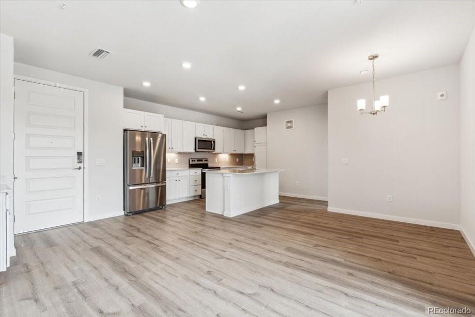 485 Interlocken Boulevard, Unit 209 Broomfield, CO 80021 - Photo 7 of 15 a kitchen with stainless steel appliances kitchen island a refrigerator sink and cabinets