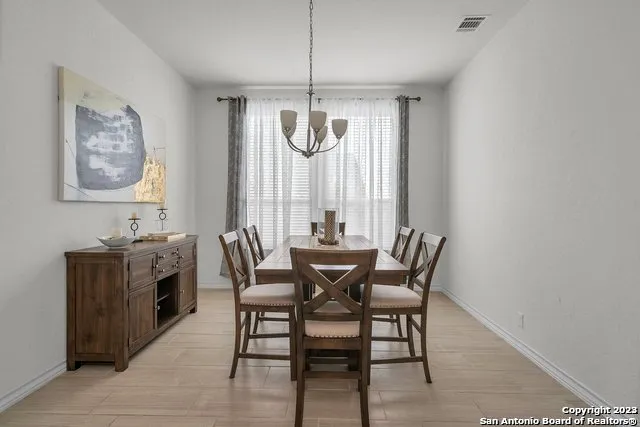 a dining room with furniture window ceiling fan and window