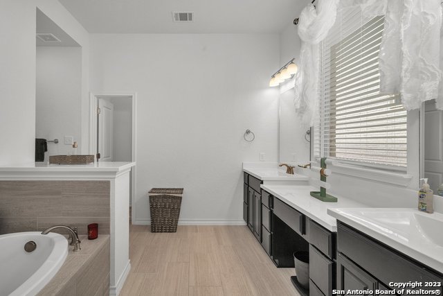 3782 Chicory Bend Bulverde, TX 78163 - Photo 20 of 41 a spacious bathroom with a double vanity sink a mirror and a bathtub