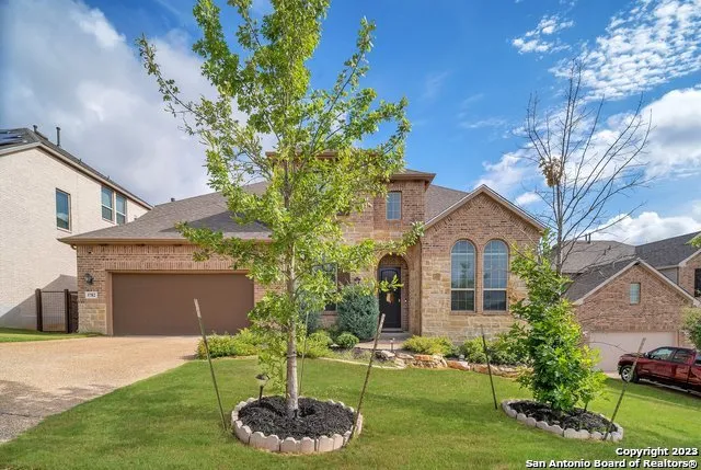 a front view of a house with a yard and garage