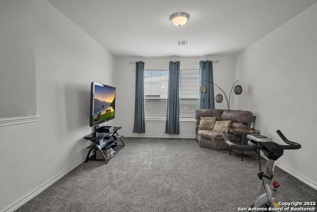 a view of a livingroom with workspace and a window