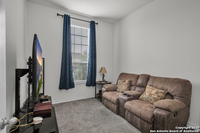 3782 Chicory Bend Bulverde, TX 78163 - Photo 29 of 41 a living room with furniture and a flat screen tv