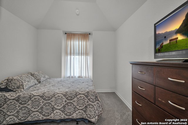 3782 Chicory Bend Bulverde, TX 78163 - Photo 30 of 41 a bedroom with a bed and a flat screen tv