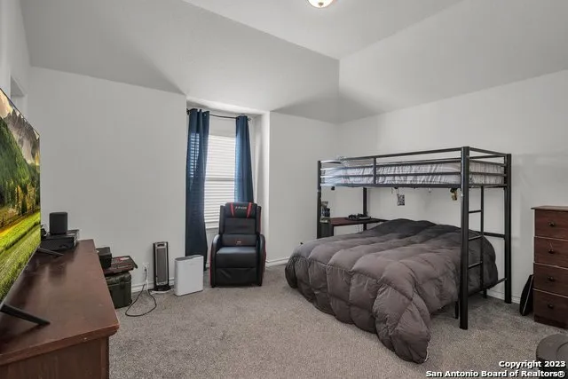 a bedroom with a bed and a flat tv screen