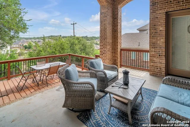 a balcony view with a couch and wooden floor
