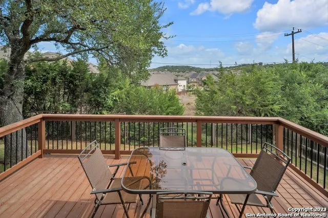 a view of a balcony with wooden floor and outdoor seating