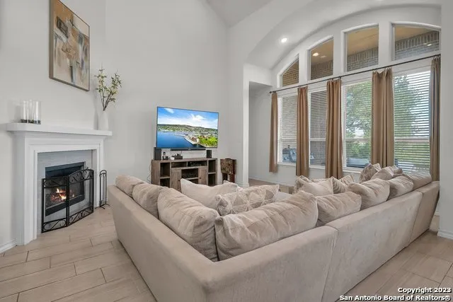 a living room with furniture window and a fireplace