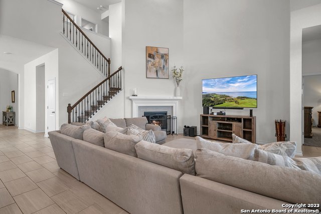 3782 Chicory Bend Bulverde, TX 78163 - Photo 8 of 41 a living room with furniture a fireplace and a flat screen tv